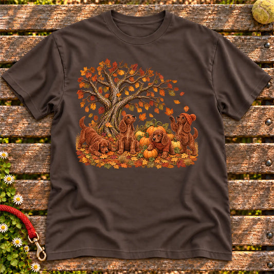 Four Irish Setter puppies with pumpkins beneath an autumn tree on a Dark Chocolate softstyle T-shirt