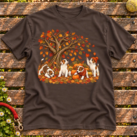 Four Jack Russell puppies with pumpkins beneath an autumn tree on a Dark Chocolate softstyle T-shirt