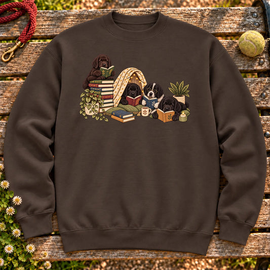 Newfie puppies reading books in a cozy blanket fort on a Dark Chocolate sweatshirt