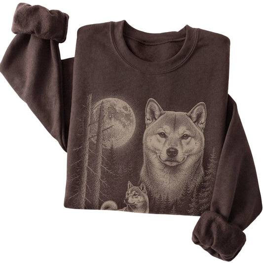 Folded dark chocolate crewneck sweatshirt showing the Shiba Inu Moonlit Forest graphic