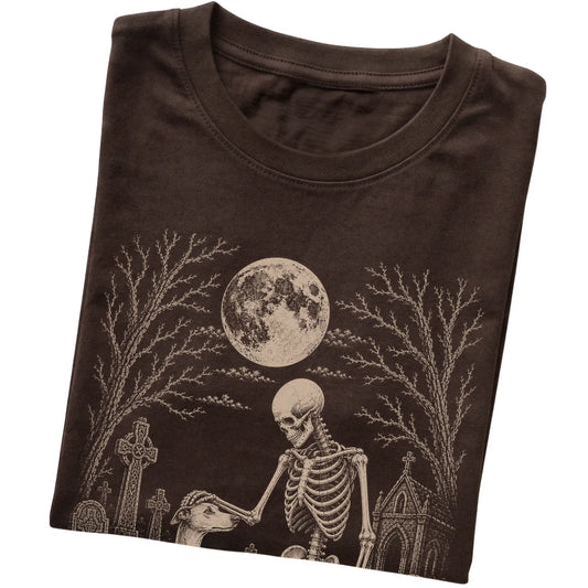Folded Dark Chocolate T-shirt with a skeleton petting a Whippet in a graveyard