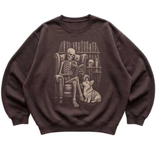Skeleton reading Tales Beyond to a Corgi on a Dark Chocolate sweatshirt