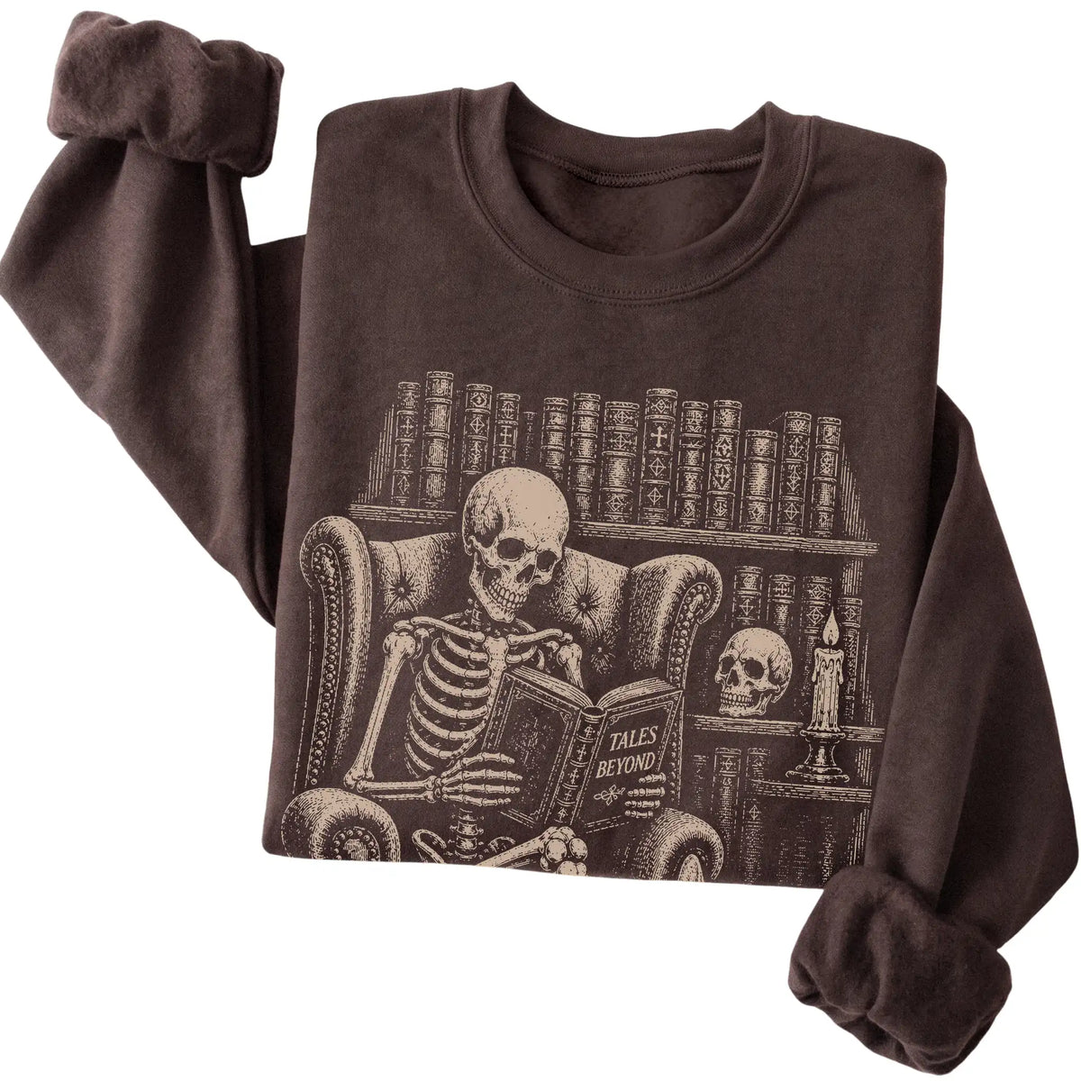 Folded Dark Chocolate sweatshirt with a skeleton reading Tales Beyond to a Corgi