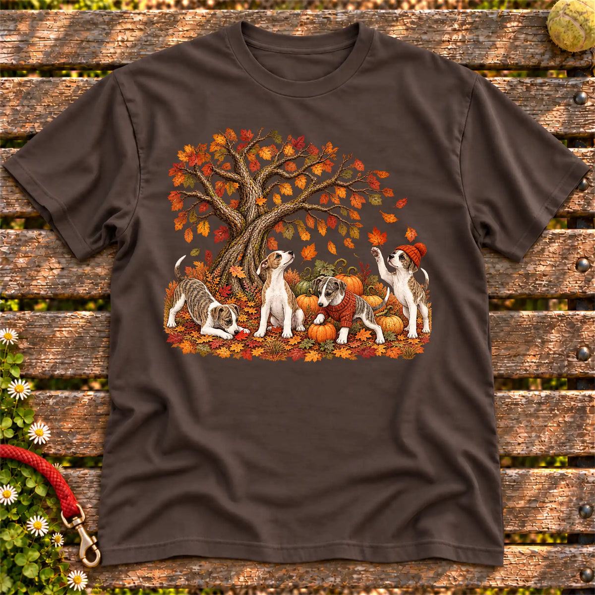 Four Whippet puppies with pumpkins beneath an autumn tree on a Dark Chocolate softstyle T-shirt