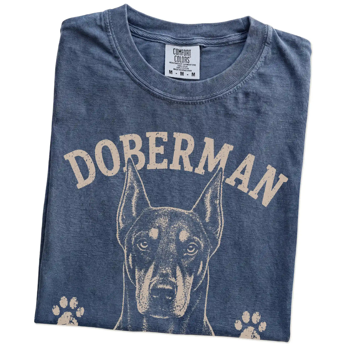 Folded Denim Comfort Colors® T-shirt showing Doberman design with “Alert, Elegant & Slightly Intimidating” lettering