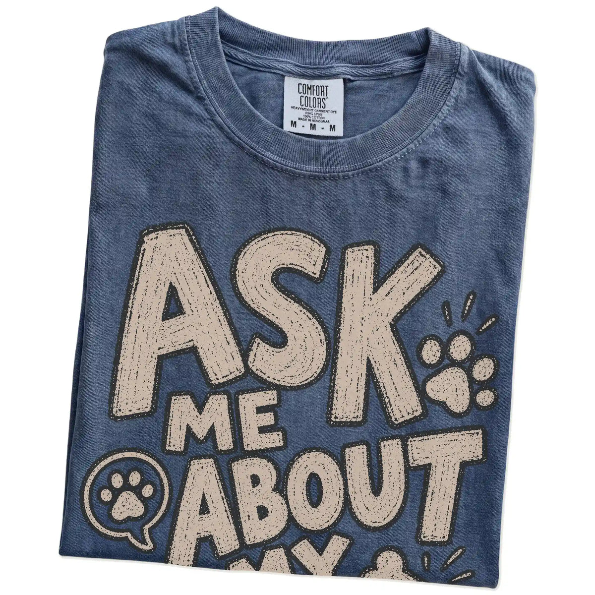 Folded Denim Comfort Colors® T-shirt showing “Ask me about my dog” lettering