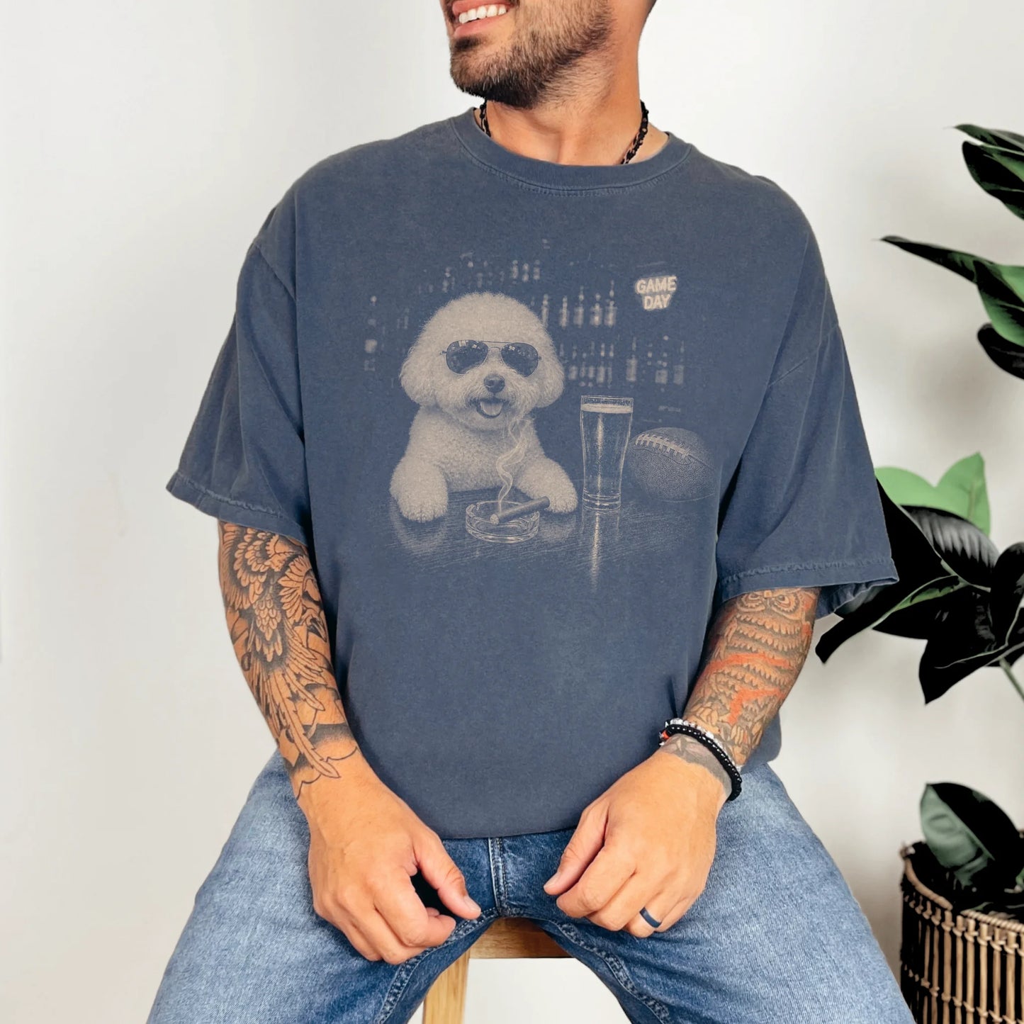 Model wearing a Denim Comfort Colors® T-shirt featuring Bichon Frise with beer and football graphics