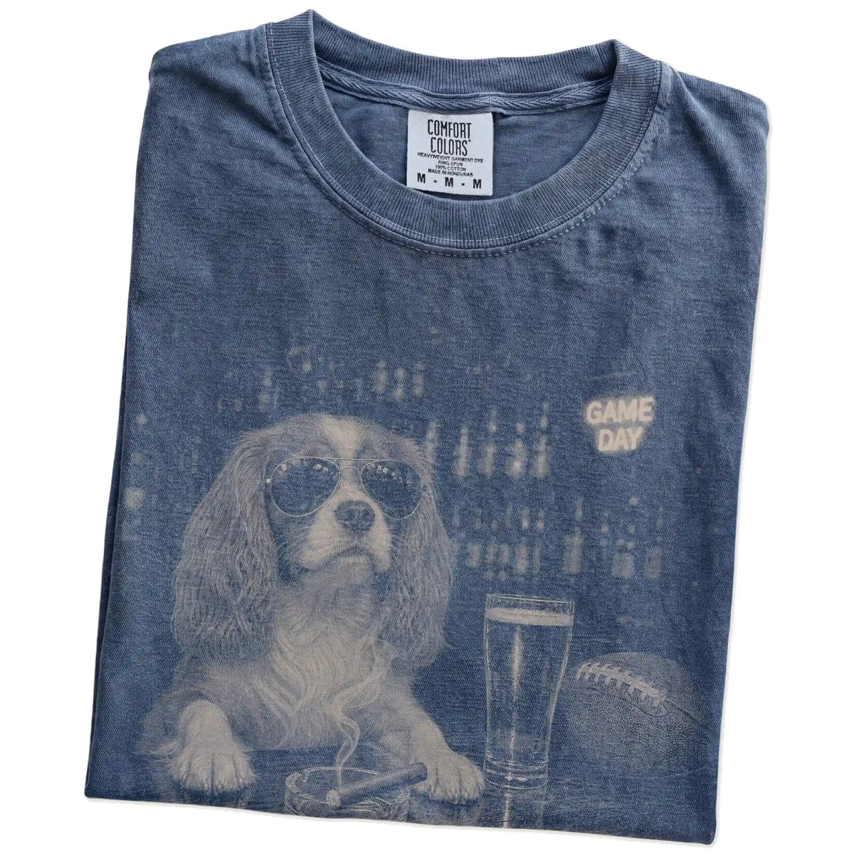 Folded Denim Comfort Colors® T-shirt showing Cavalier King Charles Spaniel with beer and football graphics
