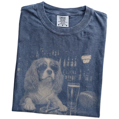 Folded Denim Comfort Colors® T-shirt showing Cavalier King Charles Spaniel with beer and football graphics