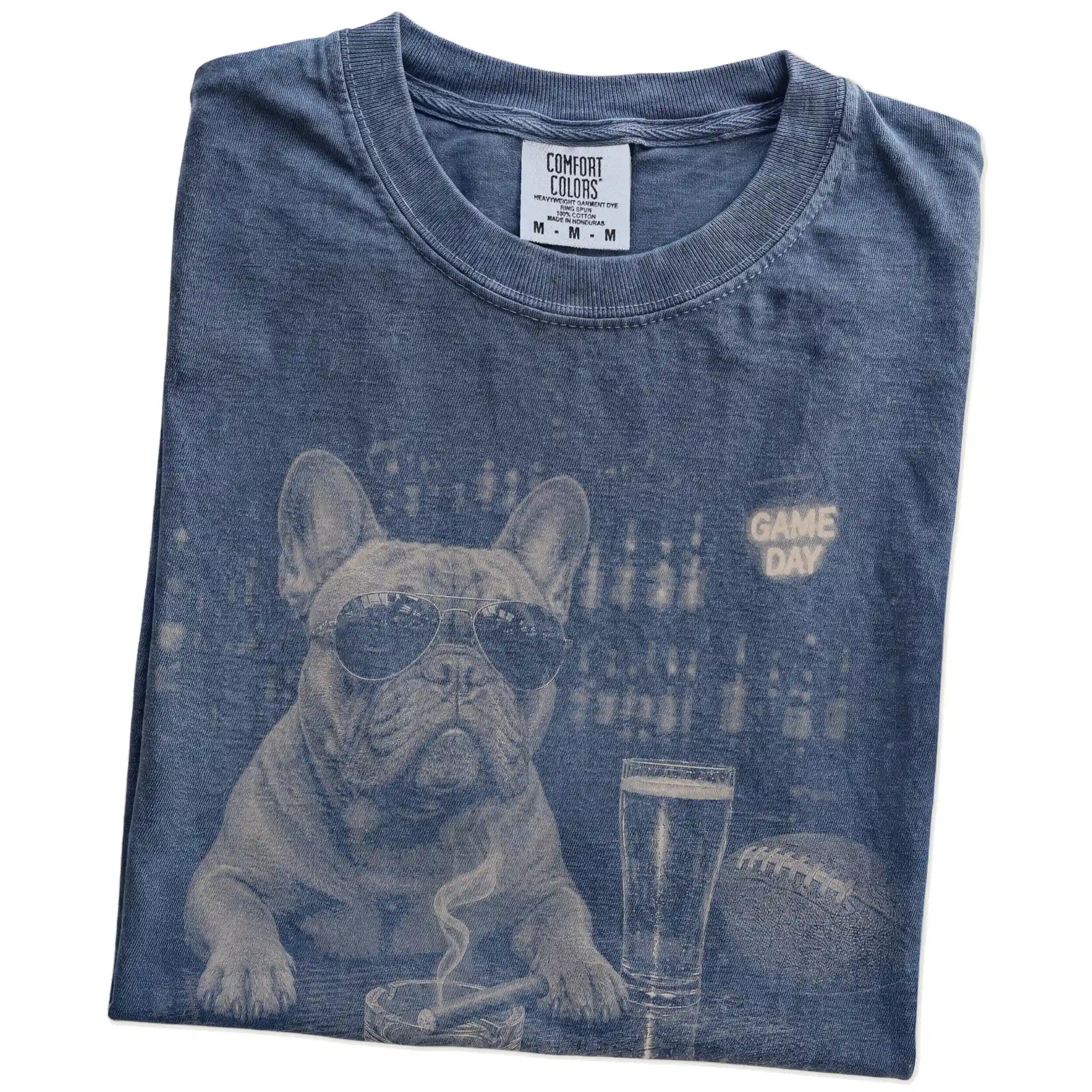 Folded Denim Comfort Colors® T-shirt showing French Bulldog with beer and football graphics
