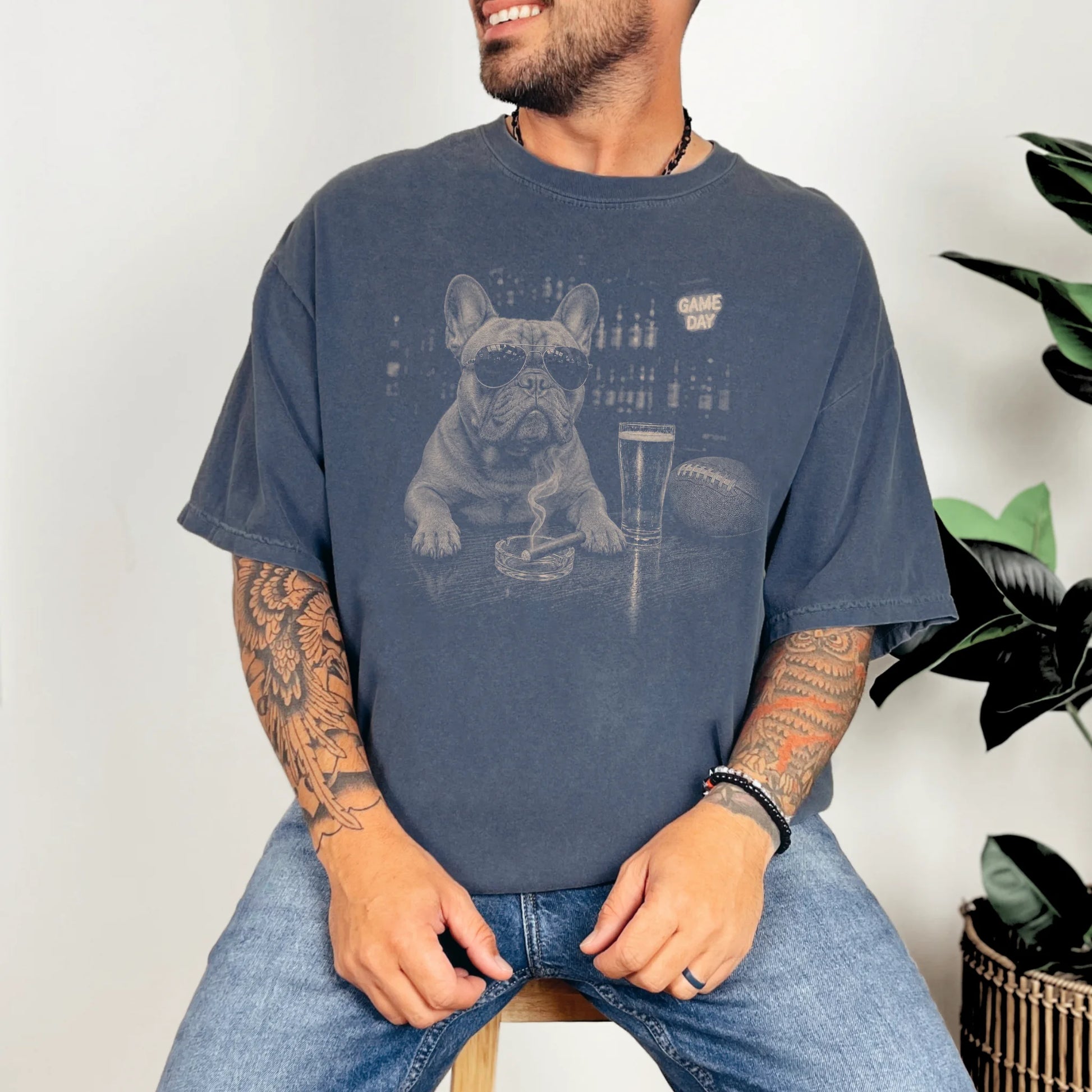Model wearing a Denim Comfort Colors® T-shirt featuring French Bulldog with beer and football graphics