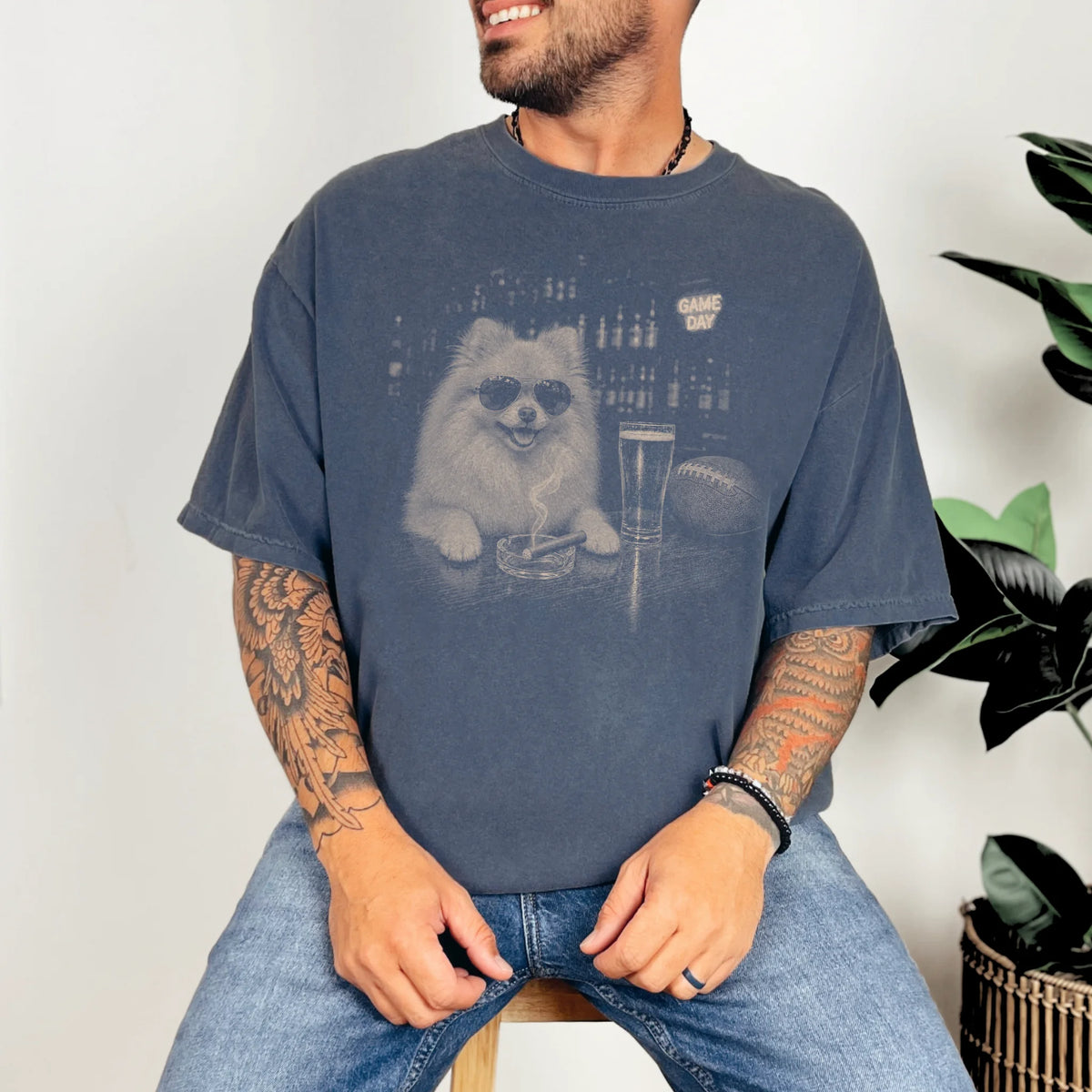 Model wearing a Denim Comfort Colors® T-shirt featuring Pomeranian with beer and football graphics