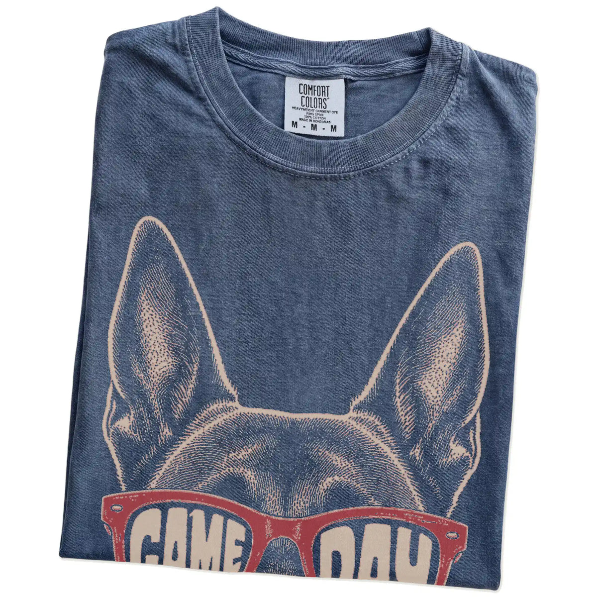 Folded Denim Comfort Colors® T-shirt showing belgian malinois wearing red game day sunglasses