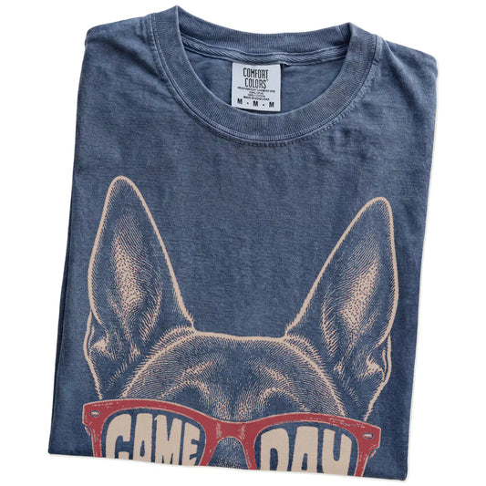Folded Denim Comfort Colors® T-shirt showing belgian malinois wearing red game day sunglasses