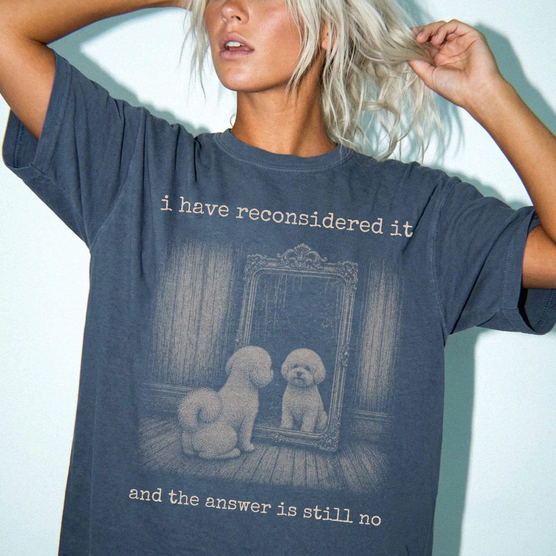 Model wearing a Denim Comfort Colors® T-shirt with “the answer is still no” bichon frise design
