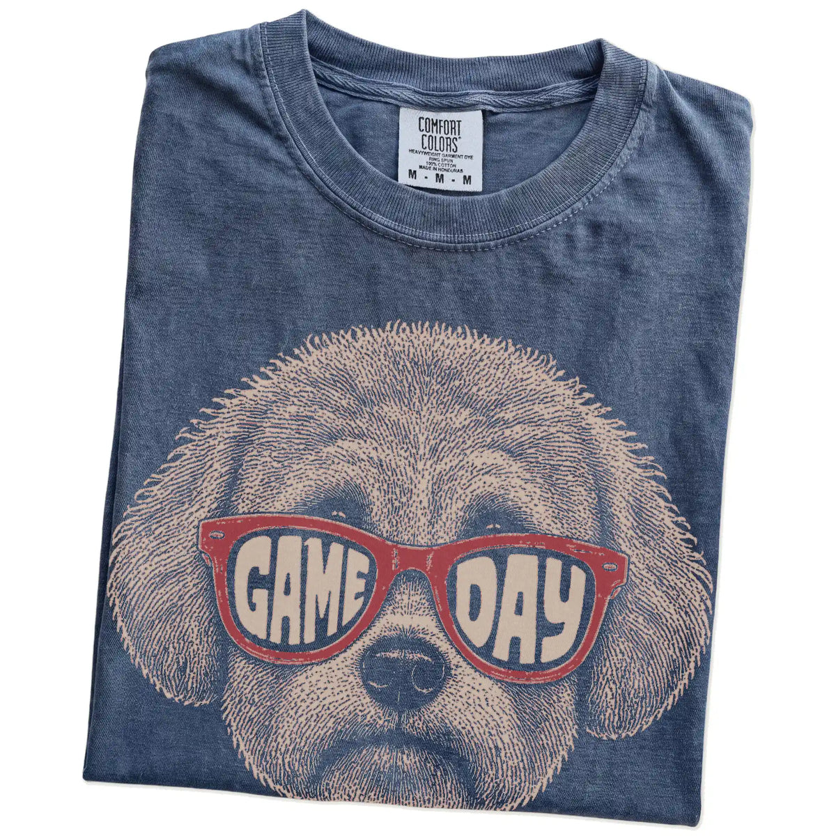 Folded Denim Comfort Colors® T-shirt showing bichon frise wearing red game day sunglasses