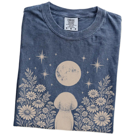 Folded Denim Comfort Colors® T-shirt showing Bichon Frise beneath a wildflower moon