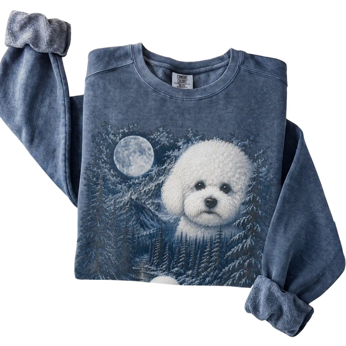 Folded denim sweatshirt with Bichon Frise Winter Moon artwork.