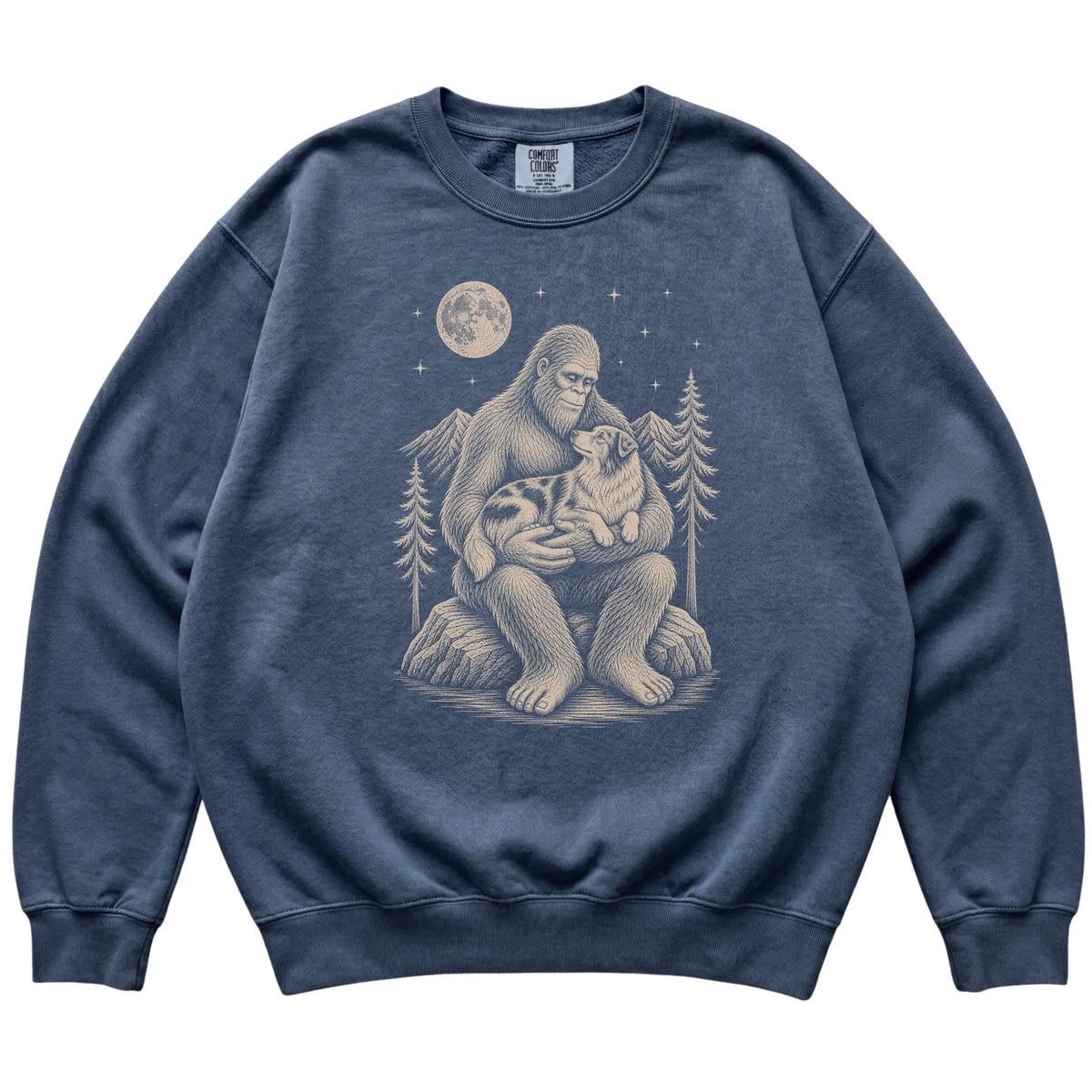 Denim sweatshirt with Bigfoot holding an Australian Shepherd under a moonlit sky