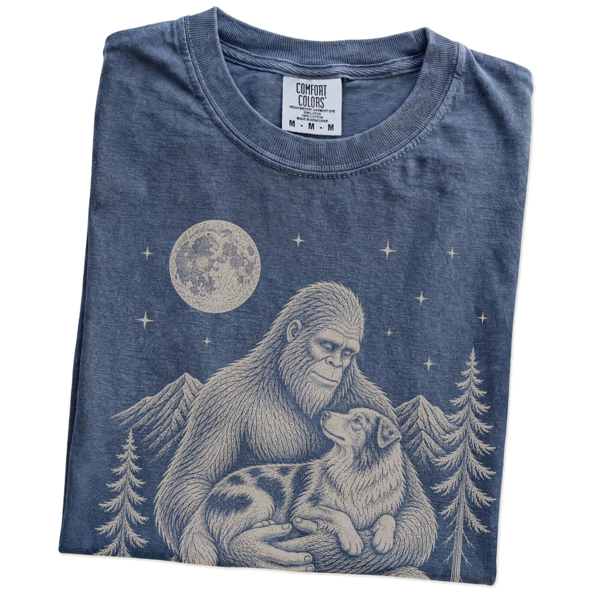 Folded Denim T-shirt showing Bigfoot holding an Australian Shepherd