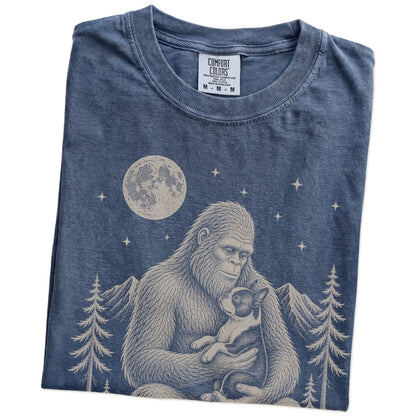 Folded Denim Comfort Colors® T-shirt showing Bigfoot holding a Boston Terrier