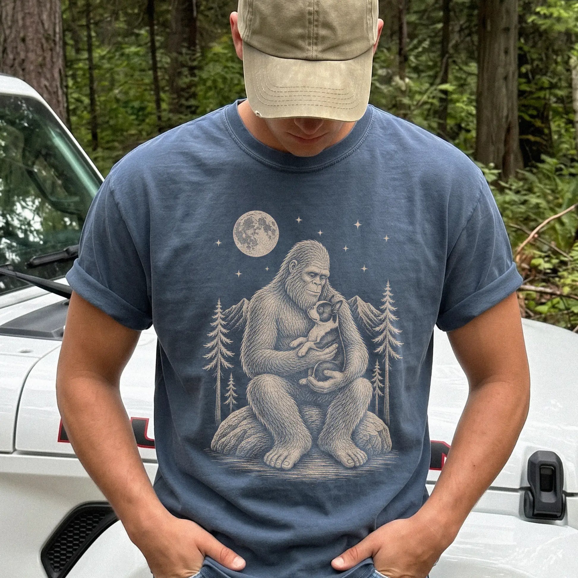 Model wearing a Denim Comfort Colors® T-shirt showing Bigfoot holding a Boston Terrier