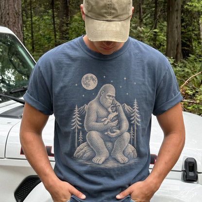 Model wearing a Denim Comfort Colors® T-shirt showing Bigfoot holding a Boston Terrier