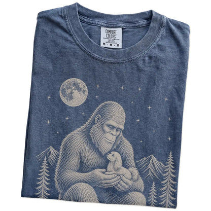 Folded Denim Comfort Colors® T-shirt showing Bigfoot holding a Maltese