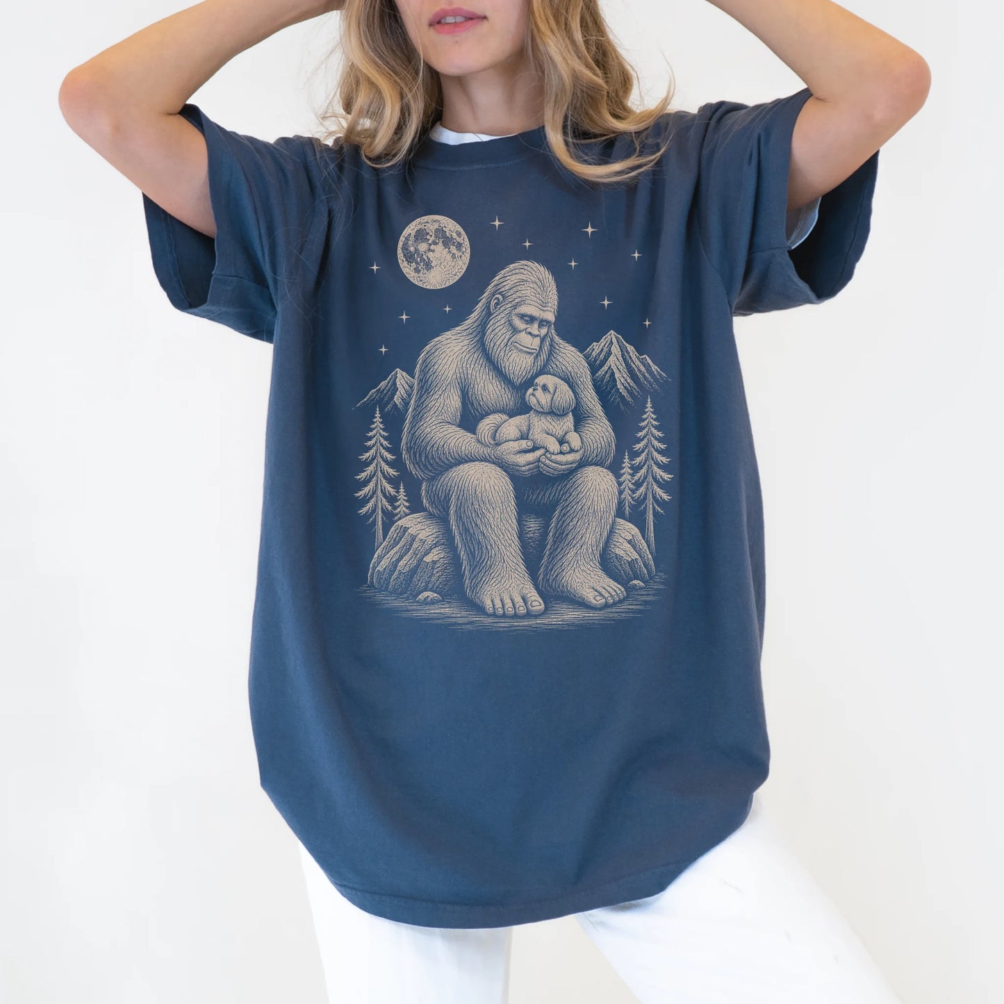 Model wearing a Denim Comfort Colors® T-shirt showing Bigfoot holding a Shih Tzu