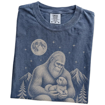 Folded Denim Comfort Colors® T-shirt showing Bigfoot holding a Shih Tzu
