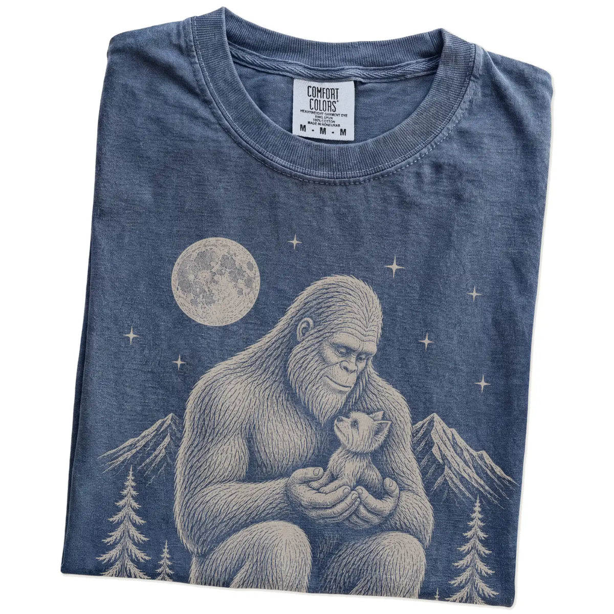 Folded Denim Comfort Colors® T-shirt showing Bigfoot holding a Yorkie