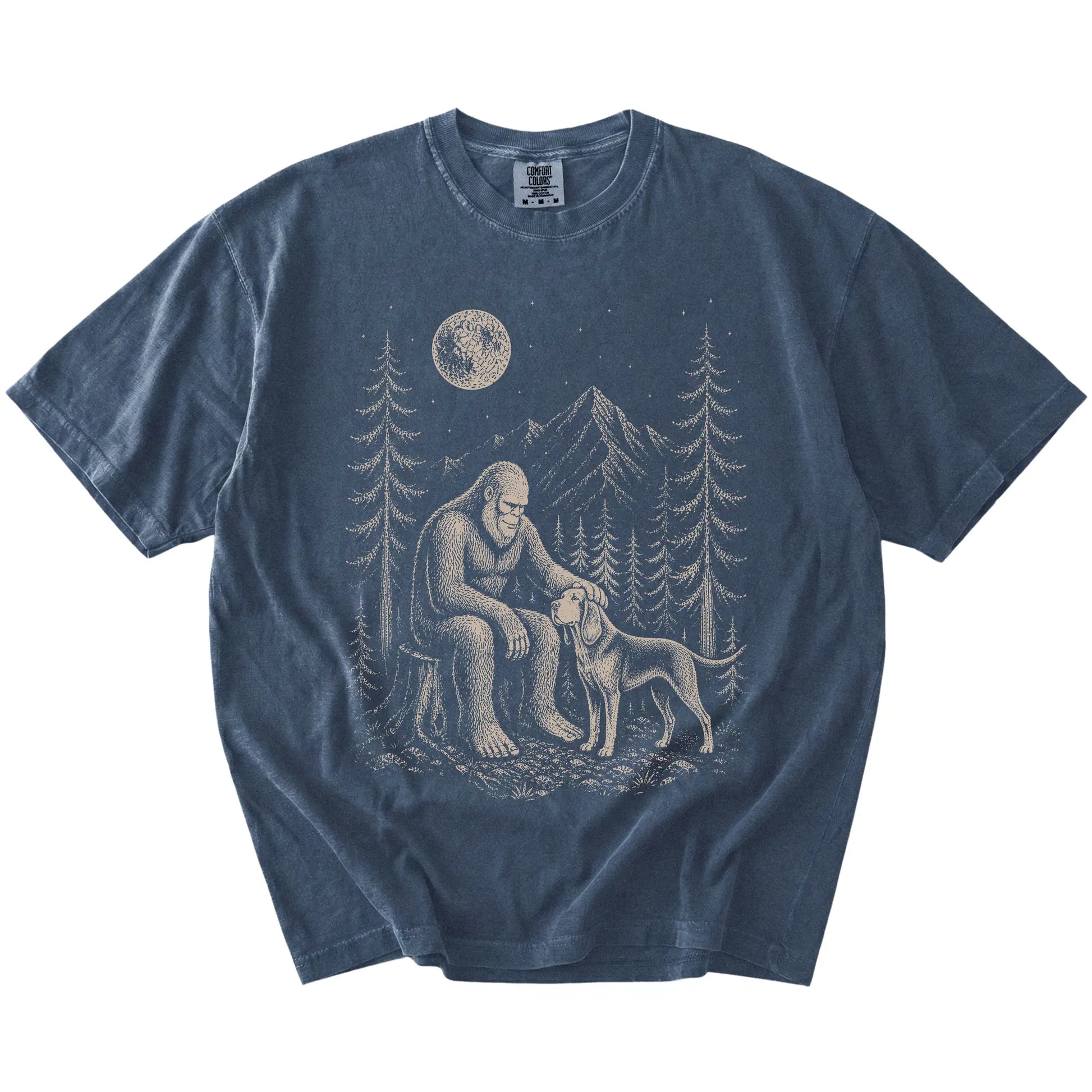 Bigfoot petting a Bloodhound beneath the moon in a pine forest on a Denim Comfort Colors® T-shirt