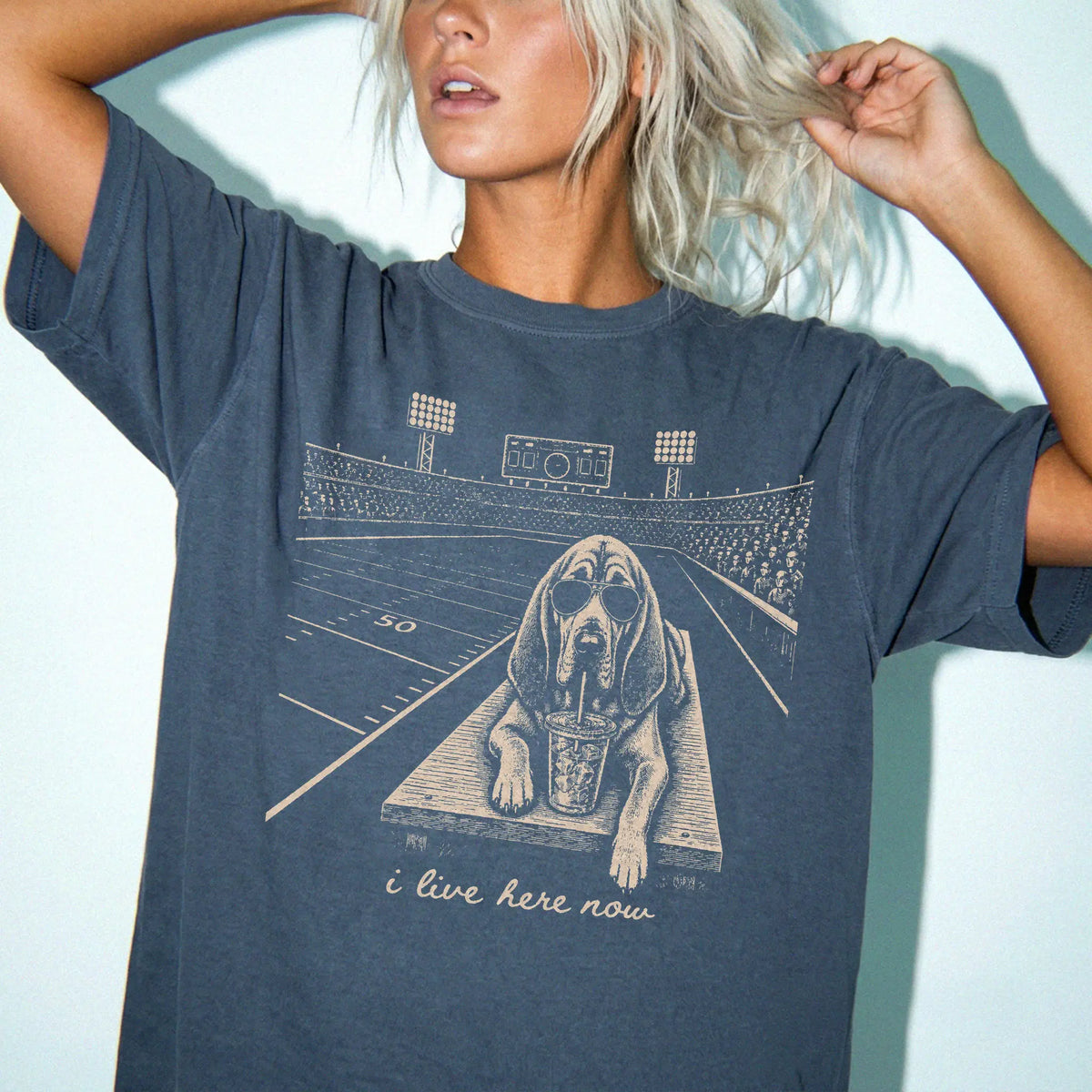 Model wearing a Denim Comfort Colors® T-shirt featuring Bloodhound ready for football and tailgate season