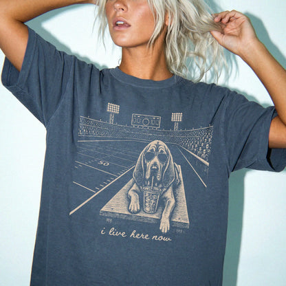 Model wearing a Denim Comfort Colors® T-shirt featuring Bloodhound ready for football and tailgate season