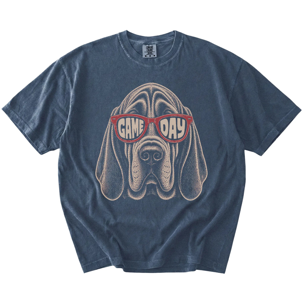 Bloodhound wearing red Game Day sunglasses on a Denim Comfort Colors® T-shirt