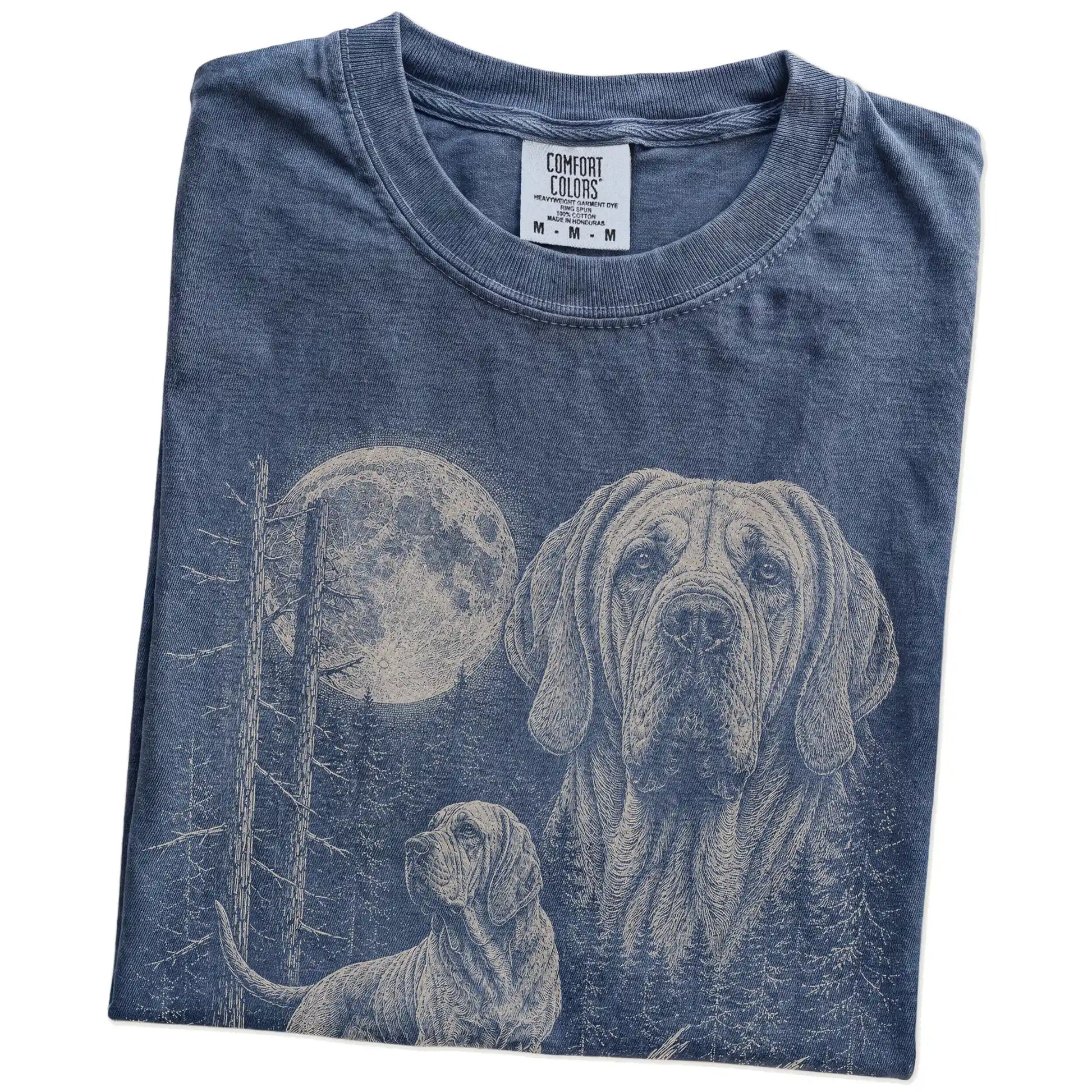 Folded Denim Bloodhound Moonlit Forest T-Shirt showing the graphic
