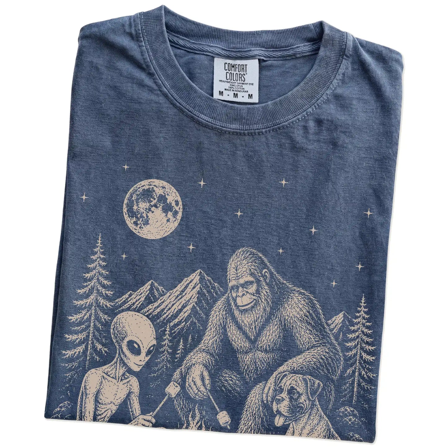 Folded Denim Comfort Colors® T-shirt showing Boxer camping with Bigfoot and an alien
