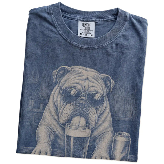 Folded Denim Comfort Colors® t-shirt showing Bulldog sneaking a drink from a pint