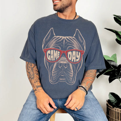 Model wearing a Denim Comfort Colors® T-shirt with cane corso wearing red game day sunglasses