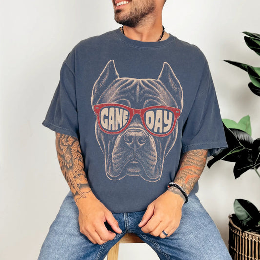 Model wearing a Denim Comfort Colors® T-shirt with cane corso wearing red game day sunglasses