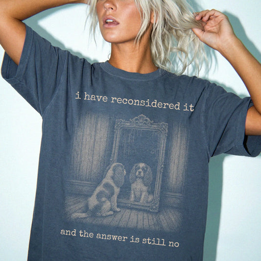 Model wearing a Denim Comfort Colors® T-shirt with “the answer is still no” cavalier king charles spaniel design