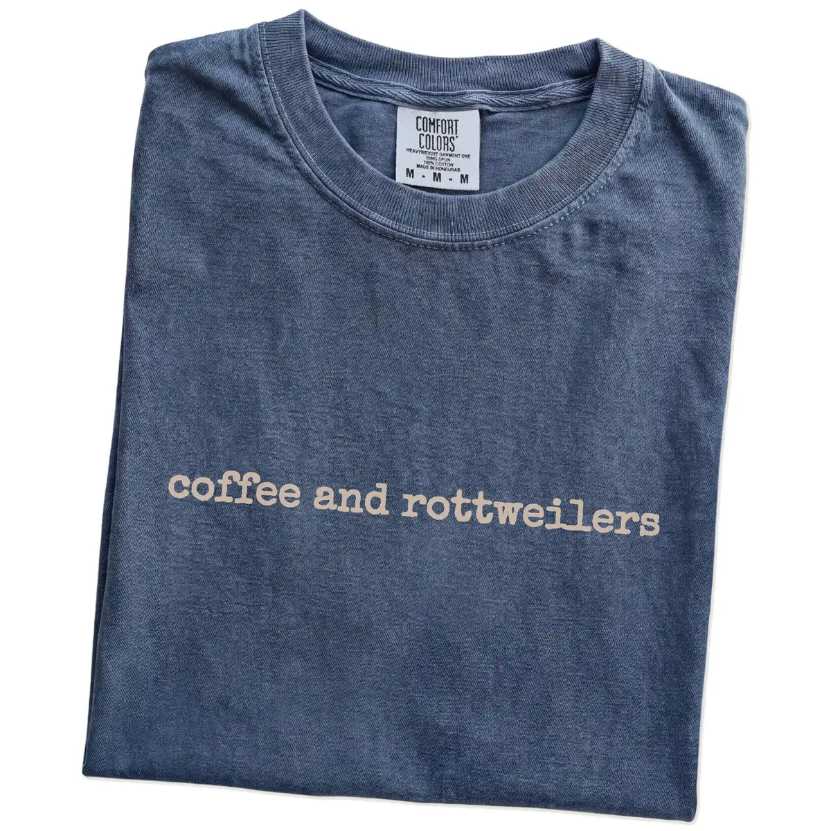 Folded Denim Comfort Colors® T-shirt showing “coffee and rottweilers” retro text