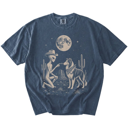 Cowboy alien fist-bumping a Collie beneath the moon on a Denim Comfort Colors® T-shirt