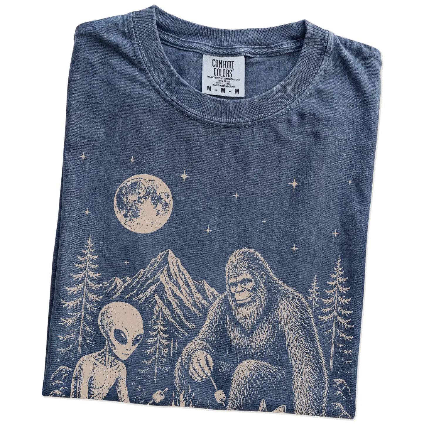 Folded Denim Comfort Colors® T-shirt showing Corgi camping with Bigfoot and an alien