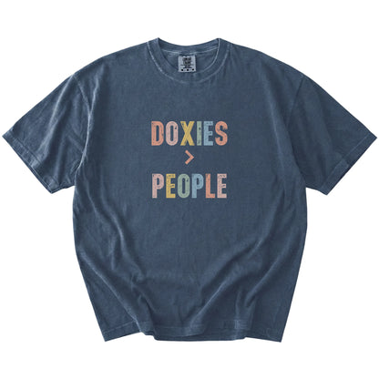 “Dachshunds > People” text on a Denim Comfort Colors® T-shirt