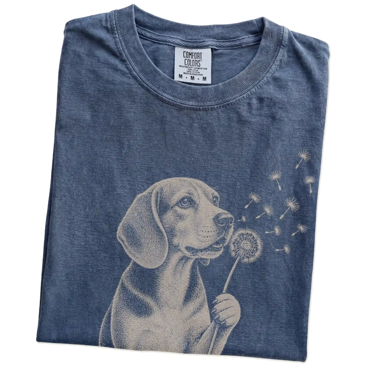 Folded Denim Comfort Colors® T-shirt showing Beagle portrait with drifting dandelion seeds
