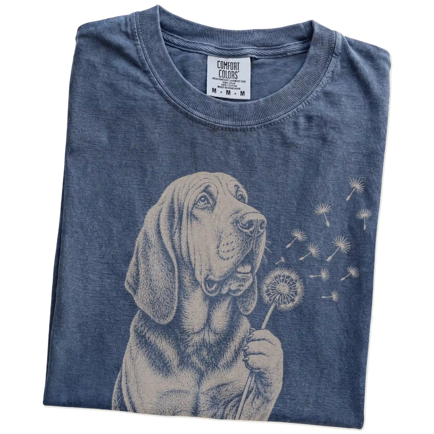 Folded Denim Comfort Colors® T-shirt showing Bloodhound portrait with drifting dandelion seeds