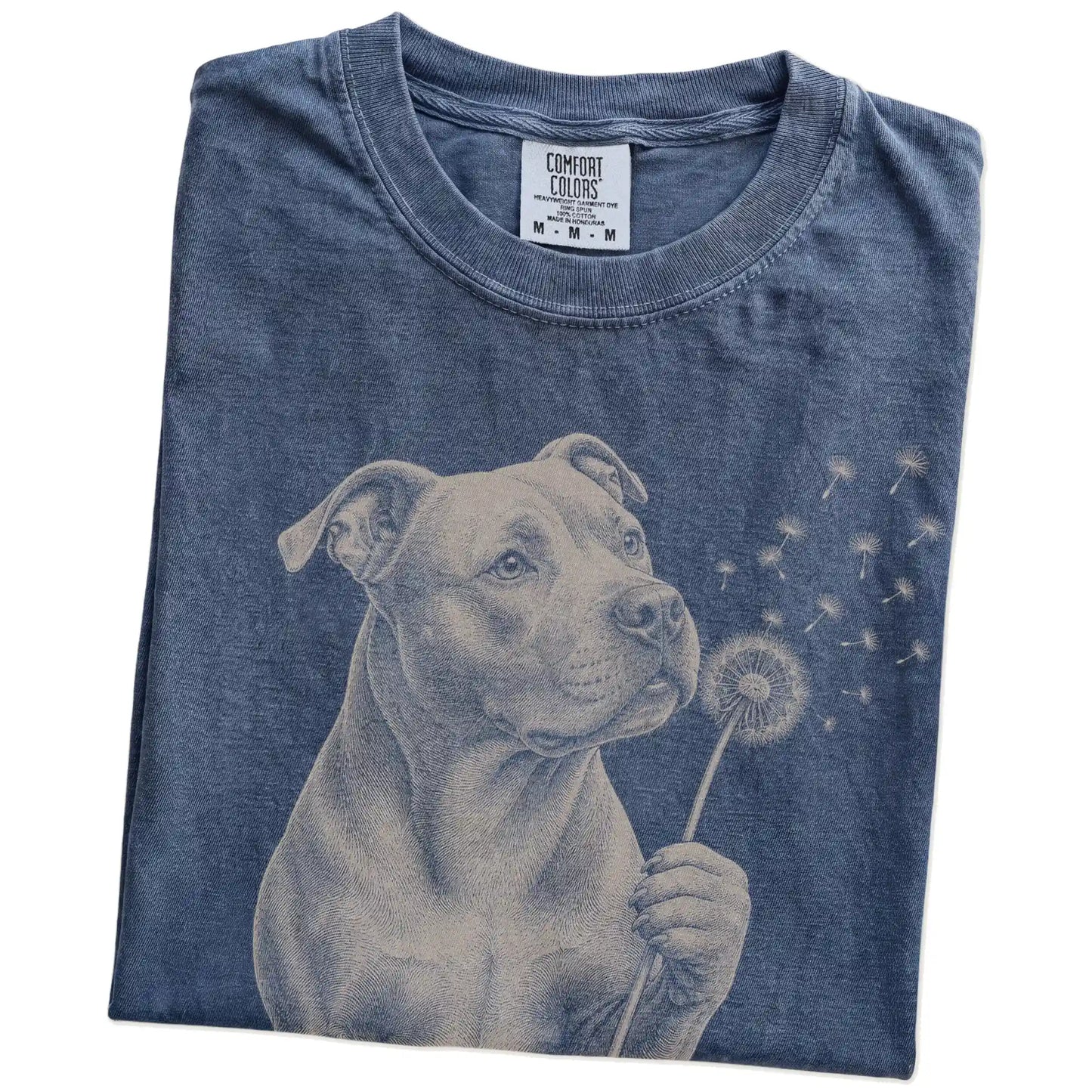 Folded Denim Comfort Colors® T-shirt showing Pitbull portrait with drifting dandelion seeds