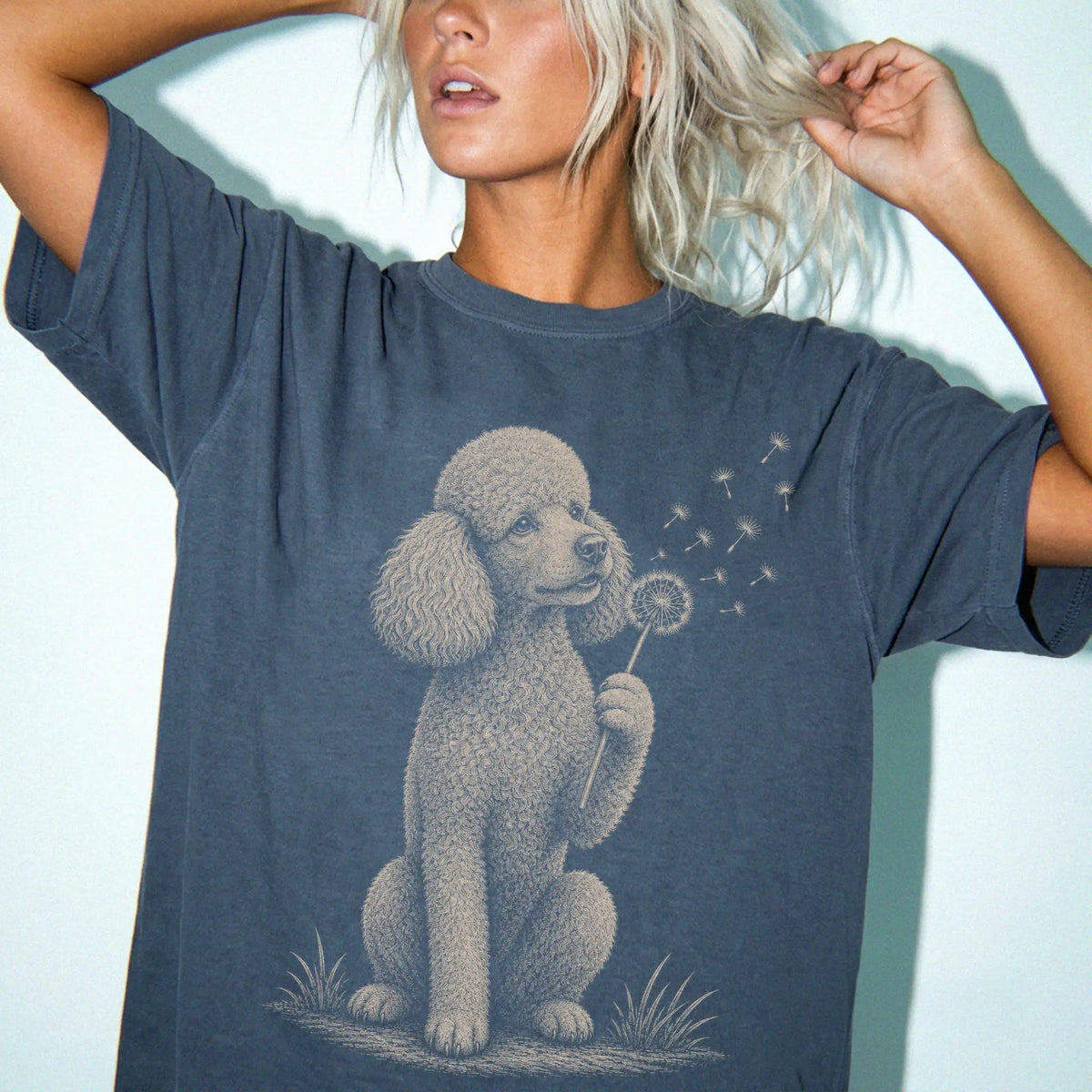 Model wearing a Denim Comfort Colors® T-shirt showing Poodle portrait with drifting dandelion seeds