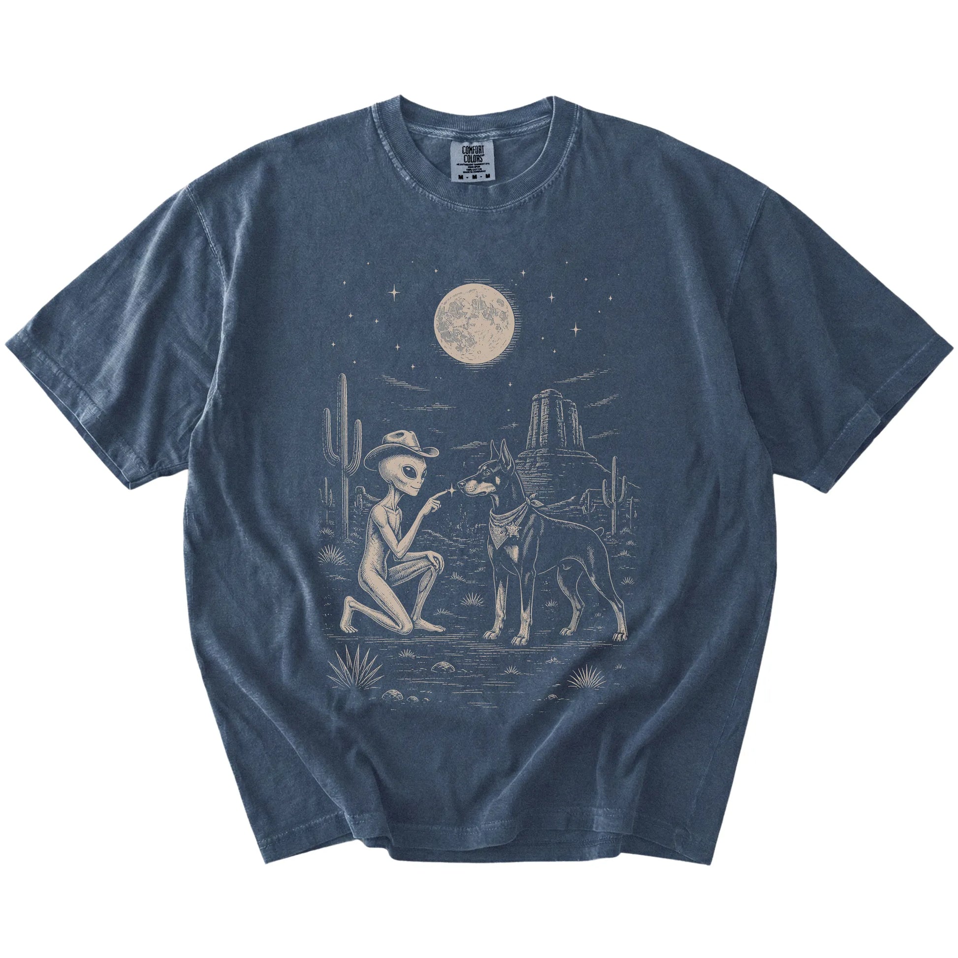 Cowboy alien fist-bumping a Doberman beneath the moon on a Denim Comfort Colors® T-shirt